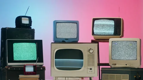 Old televisions with grey interference screen on pink red neon background Stock Footage 169373080