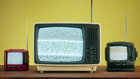 Old televisions with grey interference screen on yellow background. Close-up of Stock Footage 169548660