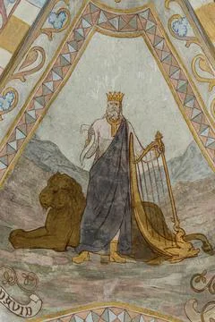 The old testament king david stands in front of a lion and holds the harp, an Stock Photos