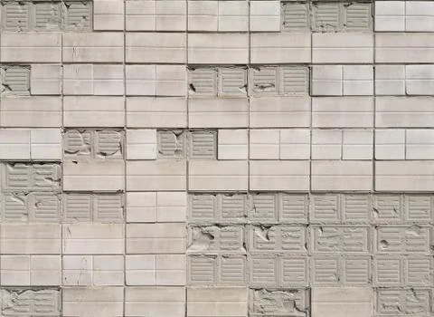 Old textured rectangular ceramic crumbling tiles on concrete wall. Foto stock