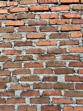 Old Textured Red Brick Wall with Rough Cement Mortar Background Stock Photos