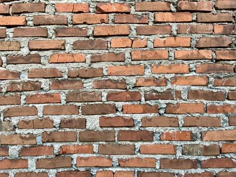Old Textured Red Brick Wall with Rough Cement Mortar Background Stock Photos