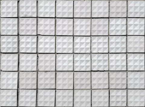 Old textured square white ceramic tiles. Stock Photos