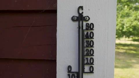 Old thermometer outside on house facade showing thirty plus degree celcius Stock Footage 211877875