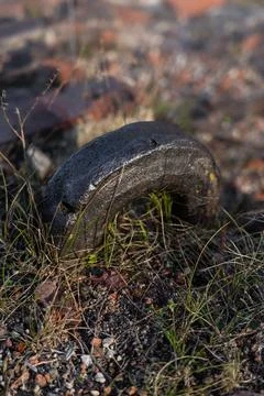 An old, thick, rusty hook sticks out of a brick fortress Stock Photos