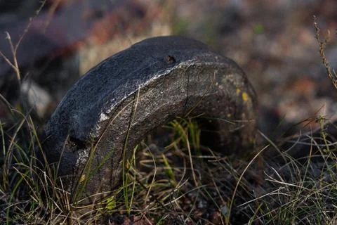 An old, thick, rusty hook sticks out of a brick fortress Stock Photos