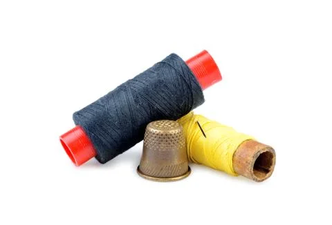 Old thimble and needle with thread isolated Stock Photos
