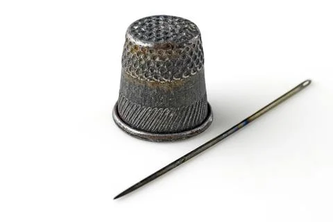 Old thimble and rusty sewing needle isolated on white background Stock Photos