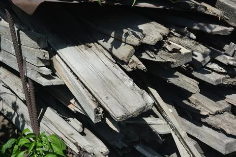 Old things and objects, old grey rotten boards of different sizes. Stock Photos