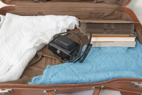Old things folded in a retro suitcase for travel. Stock Photos