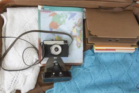 Old things folded in a retro suitcase for travel. Stock Photos
