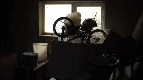 Old things stand on a table in a box against the background of a window in a Stock-Footage 126917728