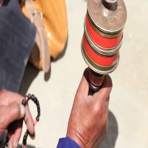 Old Tibetan woman holding buddhist prayer wheel in Lamayuru Gompa, Ladakh, India Stock Footage