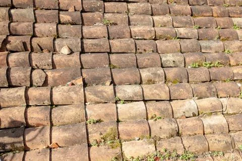 Old tile roof texture. Weathered surface of ancient roof of italian little ho Stock Photos
