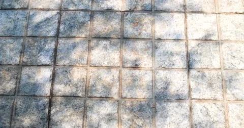 Old tiled floor with sunlight and leaf shadows creating natural patterns Stock Footage 332549418
