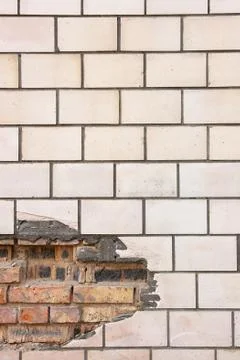 Old tiled wall with a broken red bricks. Stock Photos
