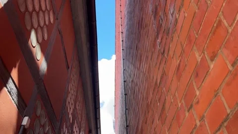 Old Timber Facade and Brick Wall Along Narrow Building Gap Stock Footage 341968660