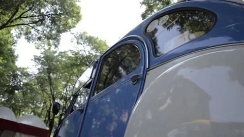 Old timer citroen 2cv dualcolo lateral low view Stock Footage 84298048
