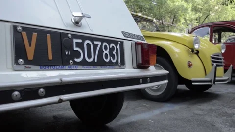 Old timer citroen 2cv white and yellow rear view Stock Footage 84298257