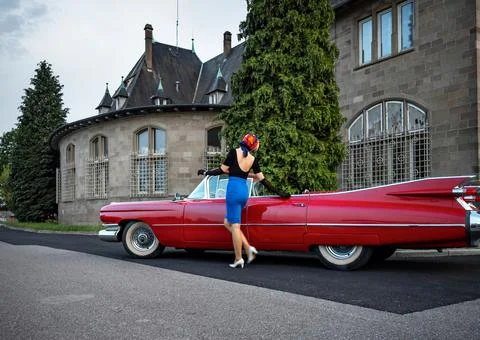 Old-timer red Cadillac and a beautiful young girl Stock Photos