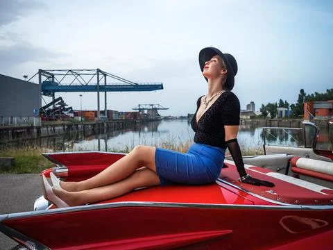 Old-timer red Cadillac and a beautiful young girl Stock Photos