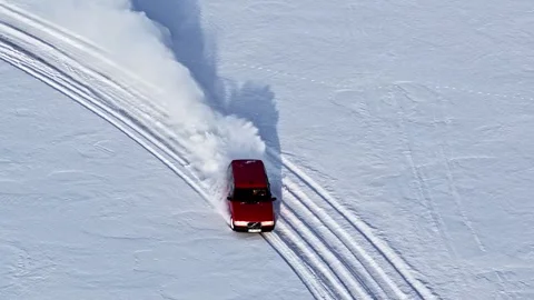 Old timer Volvo roaring engine on pristine snow, full throttle sliding stunt Stock Footage 332057300