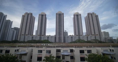 Old tiny houses surrounded by new modern high rise apartments,Singapore Stock Footage 124622805