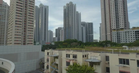 Old tiny houses surrounded by new modern high rise apartments,Singapore Stock Footage 124622825