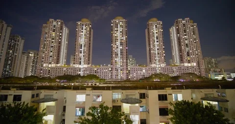 Old tiny houses surrounded by new modern high rise apartments built Stock Footage 124622827