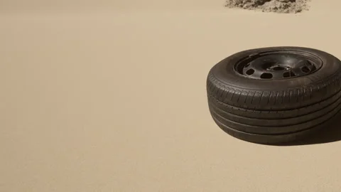 Old tire rests on sandy ground in an open area near the beach Stock Footage 342809045
