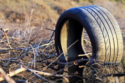 Old tire on the roadside 스톡 사진
