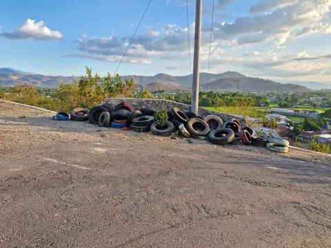 Old tires stacked at a sharp bend, a precautionary measure to prevent accid.. Stock Photos
