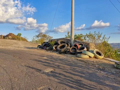 Old tires stacked at a sharp bend, a precautionary measure to prevent accid.. Stock Photos