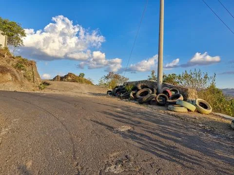 Old tires stacked at a sharp bend, a precautionary measure to prevent accid.. Stock Photos