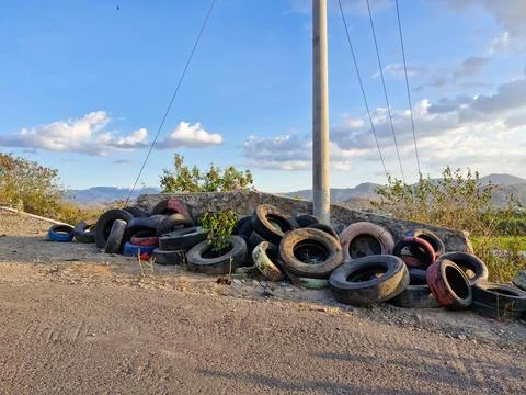 Old tires stacked at a sharp bend, a precautionary measure to prevent accid.. Stock Photos