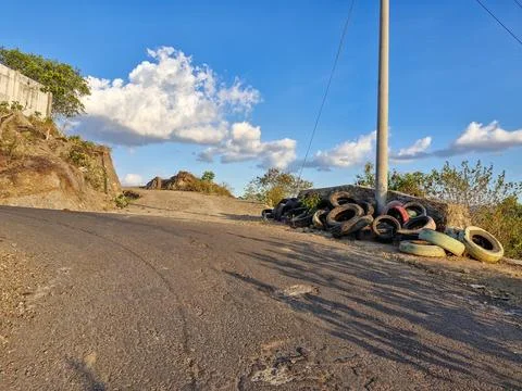 Old tires stacked at a sharp bend, a precautionary measure to prevent accid.. Stock Photos