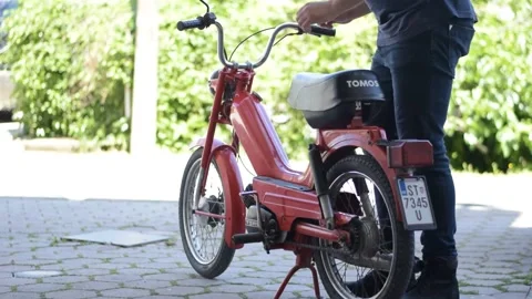 Old Tomos motorcycle startup Stock Footage 154247988