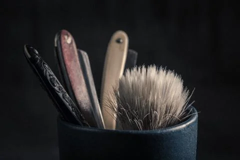 Old tools for barber. Sharp razor, soap and brush Stock Photos