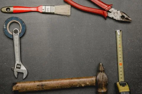 Old tools set on dark background. Father's day concept with empty space for c Stock Photos