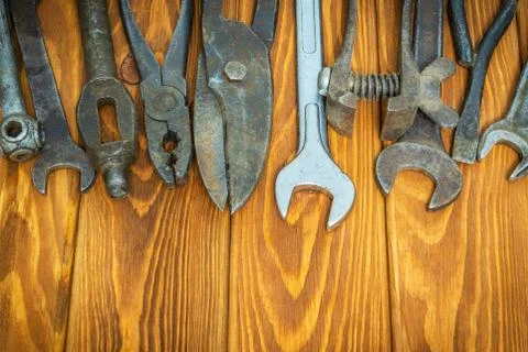 Old tools stacked after work on vintage wood background Stock Photos