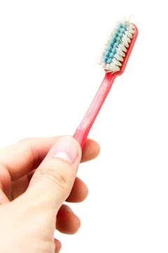 Old toothbrush in hand Stock Photos