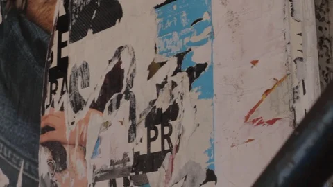 Old torn poster paper scraps texture on street wall Stock Footage 106535798