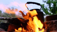 An Old Kettle Over The Camp Fire. The Kettle Boils Water For Tea Stock  Photo, Picture and Royalty Free Image. Image 84570904.