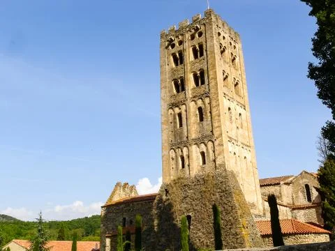 An old tower made of stone in front of the blue sky Stock Photos