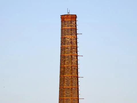 Old Tower Restoring. Restoring Ancient Brick Chimney With Scaffolding Amids.. Stock Photos