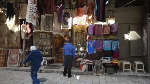 Old Town Jerusalem shop side view with two shopkeepers in front Stock Footage 33730096