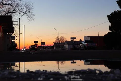 Old town at sunset reflected on a puddle Stockfoto's