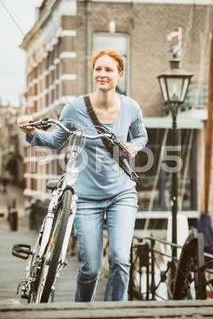 Old Town - Woman with a Bicycle Stock Photos