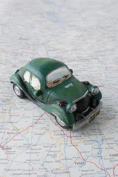 Old toy car on map Stock Photos