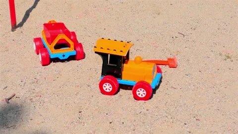 Old Toy Plastic Tractor in The Sand. Видео 159751917
